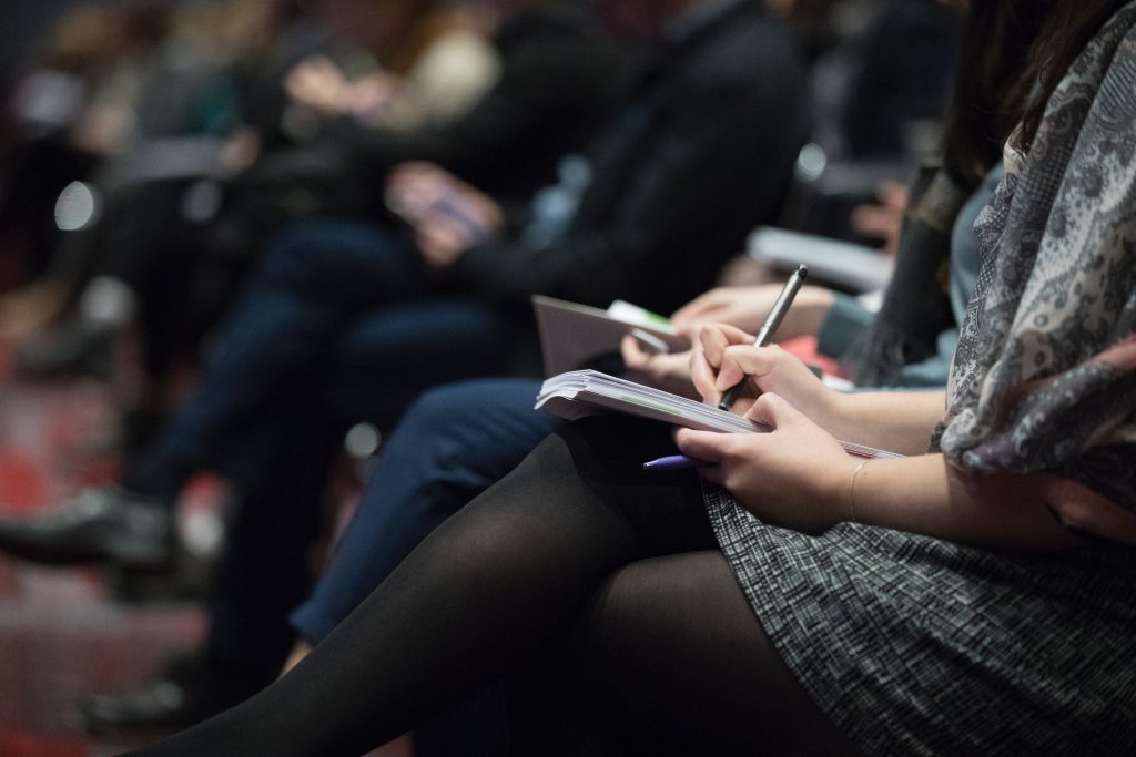 audience taking notes during presentation