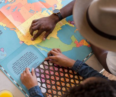 An adult teaching a child how to read a map