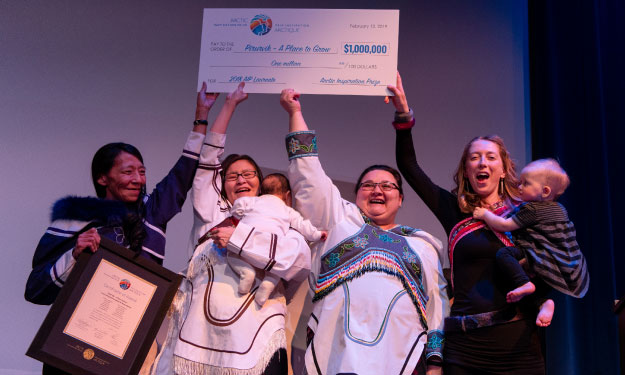 A group of people holding a large cheque